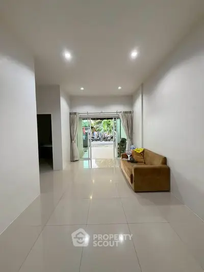 Spacious living room with modern design and large windows offering natural light.