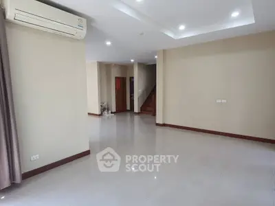 Spacious empty living room with modern air conditioning and elegant tile flooring