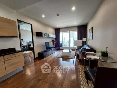 Modern living room with sleek furniture and city view balcony, perfect for urban living.