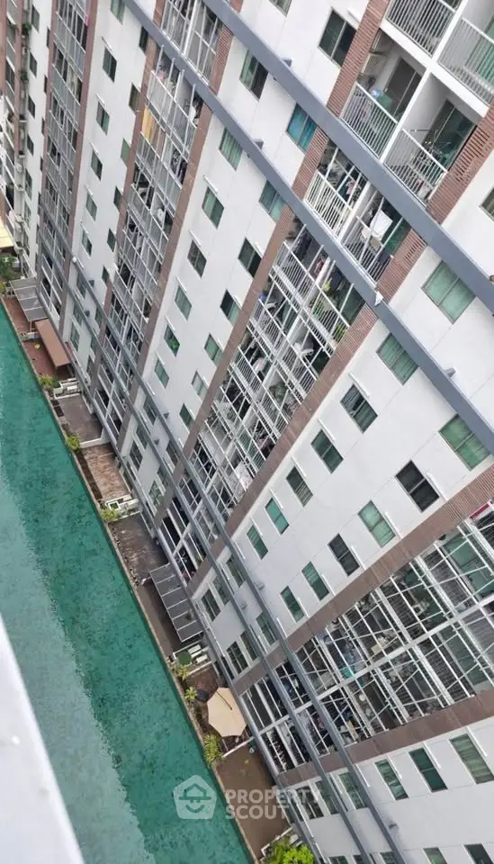 Stunning high-rise building with pool view, perfect for modern urban living.