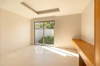 Spacious empty room with large window and natural light in modern home