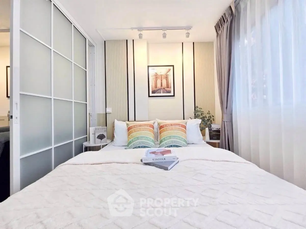 Cozy bedroom with modern decor and natural light, featuring a comfortable bed and stylish accents.