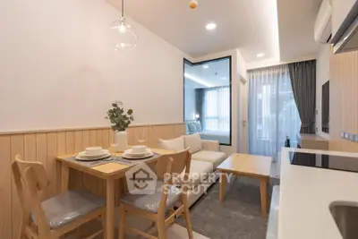 Modern open-layout living room with dining area and cozy sofa, perfect for urban living.