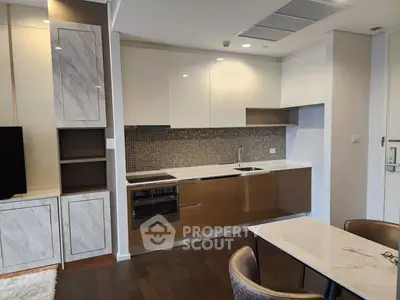 Modern kitchen with sleek cabinetry and integrated appliances in a stylish apartment.