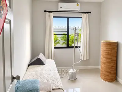 Cozy minimalist bedroom with air conditioning and natural light