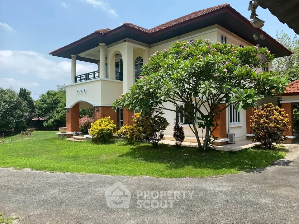 Charming two-story house with lush garden and spacious lawn