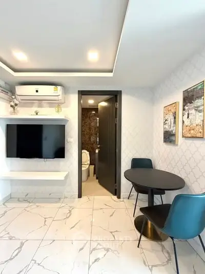 Modern living room with sleek design, marble flooring, and stylish furniture.