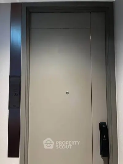 Modern apartment door with electronic lock and room number 305, sleek design for secure living.