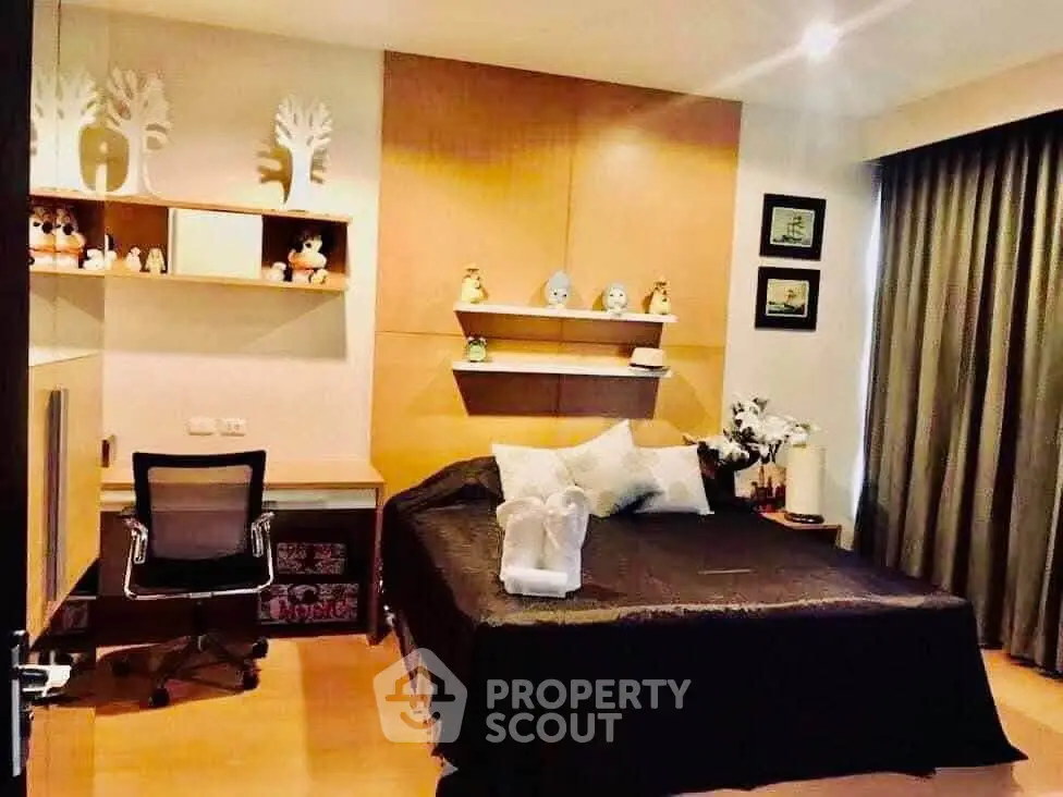 Cozy bedroom with modern decor and workspace, ideal for relaxation and productivity.