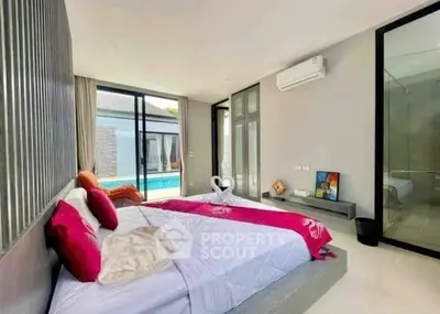 Luxurious bedroom with pool view, modern decor, and air conditioning in a stylish home.