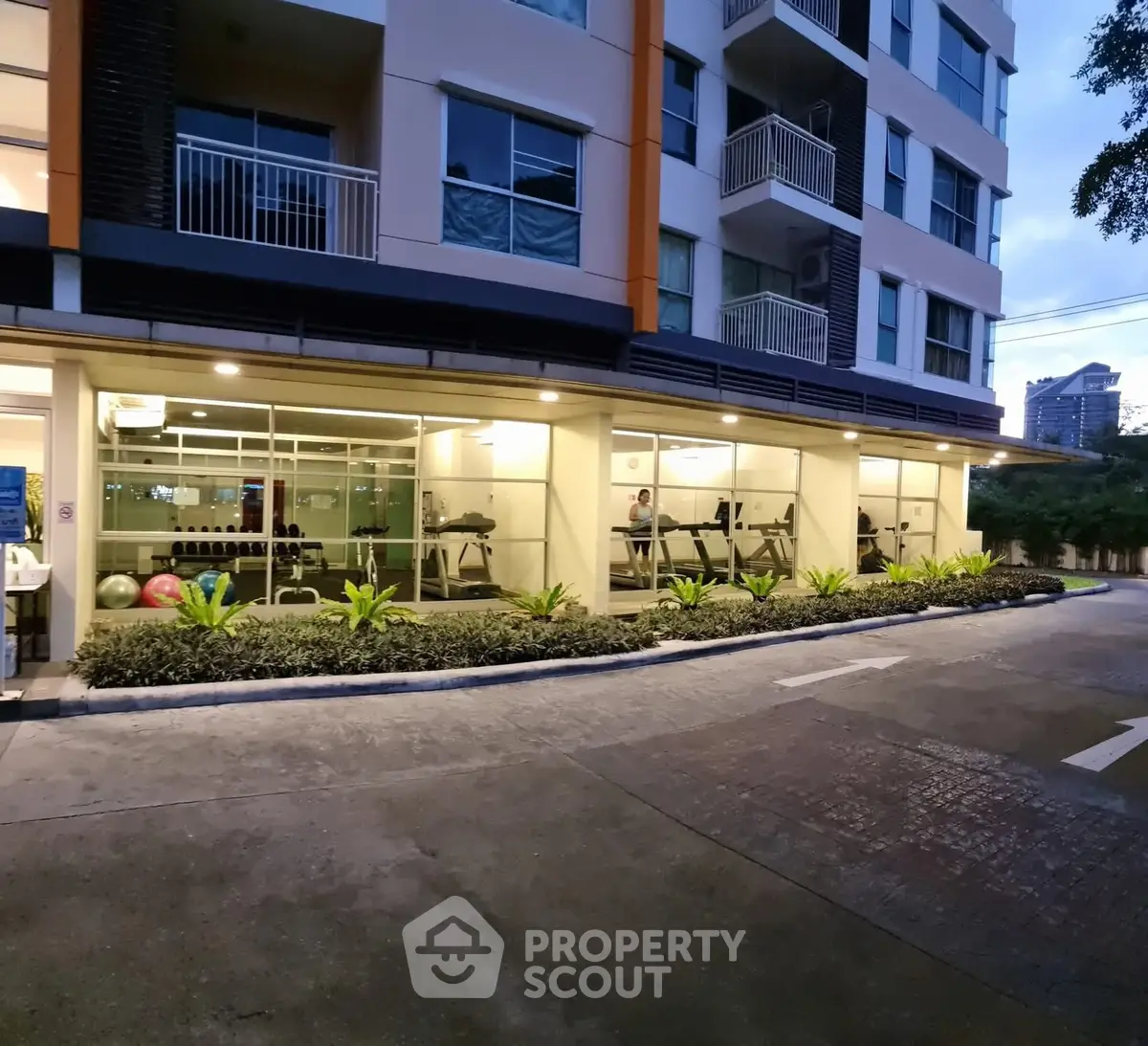 Modern apartment building with gym and landscaped entrance