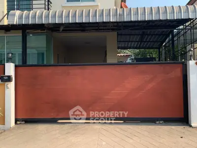 Modern house entrance with stylish wooden gate and covered carport