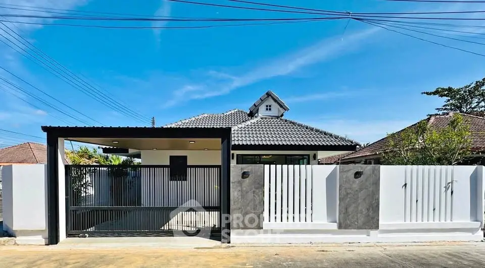 Charming single-story home with modern gate and sleek exterior design, perfect for family living.