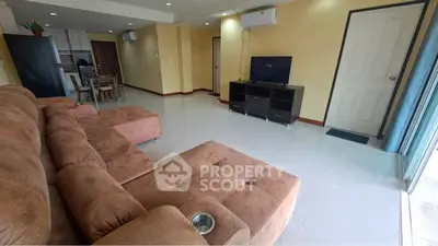 Spacious living room with plush sectional sofa and modern entertainment center.
