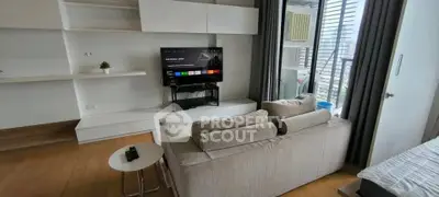 Modern living room with sleek furniture and balcony view in a stylish apartment.