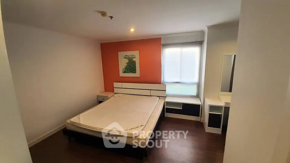 Cozy bedroom with modern furniture and warm lighting, perfect for relaxation.