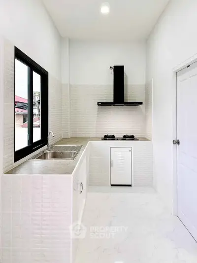 Modern kitchen with sleek design, featuring gas stove and ample counter space, perfect for culinary enthusiasts.