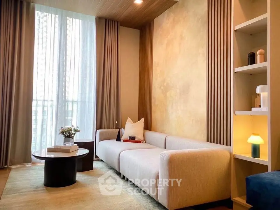 Elegant living room with modern sofa and stylish decor, featuring floor-to-ceiling windows and ambient lighting.