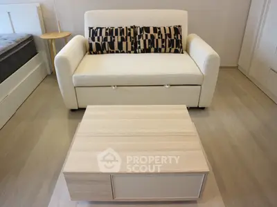 Modern living room with stylish sofa and wooden coffee table in cozy apartment.