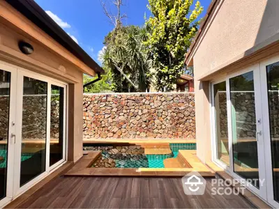 Luxurious villa with private pool and elegant wooden deck, perfect for relaxation and entertaining.