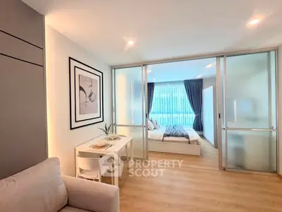 Modern studio apartment with sliding glass doors and cozy dining area.