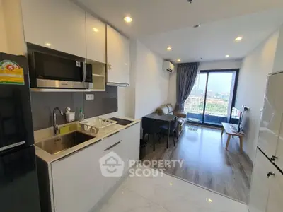 Modern open-layout kitchen and living room with city view balcony