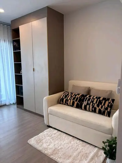 Cozy living room with modern sofa and built-in storage, perfect for urban living.