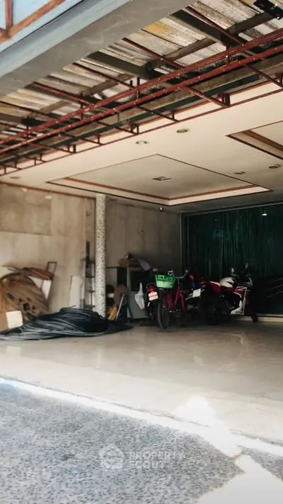Spacious garage with motorbikes and storage space in a modern building.