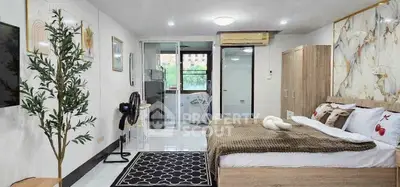 Spacious modern bedroom with stylish decor and large windows offering natural light.