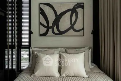 Luxurious bedroom with modern art and plush pillows in a stylish apartment