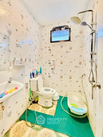 Charming bathroom with unique tile design and modern fixtures, perfect for a cozy home.