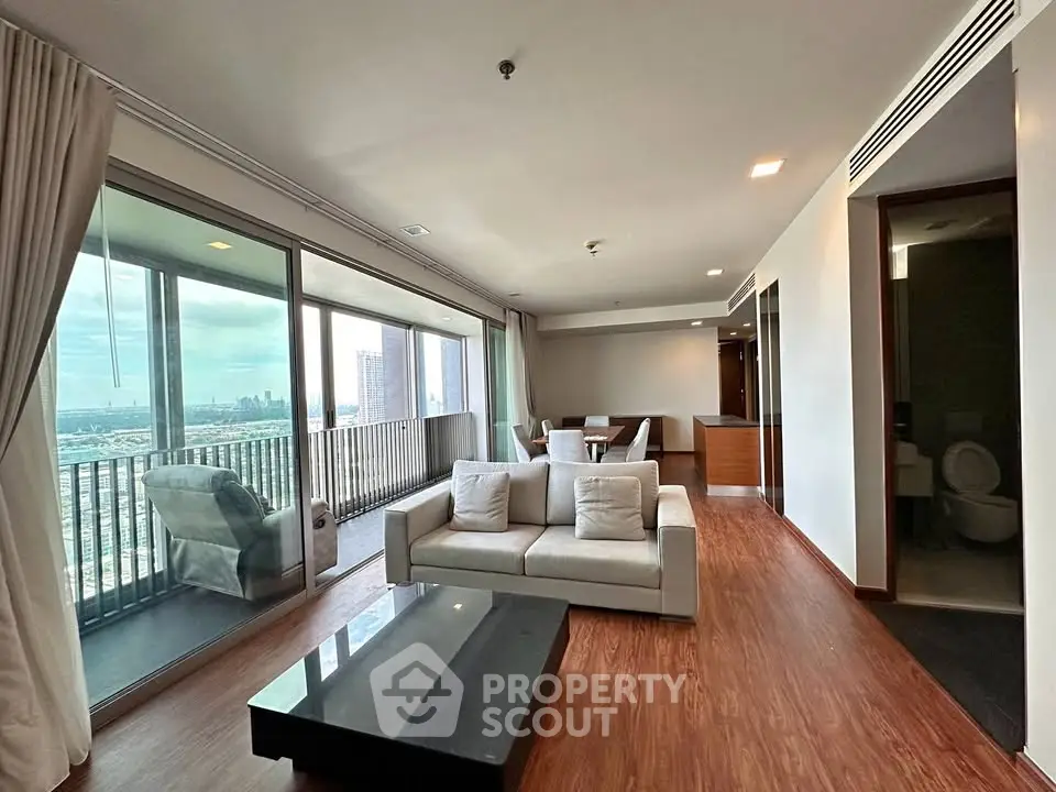 Spacious modern living room with large balcony and stunning city view