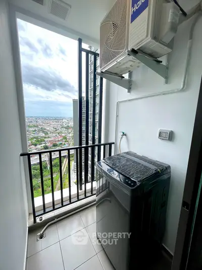 High-rise apartment balcony with washing machine and stunning city view
