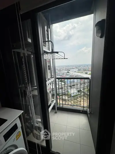 High-rise balcony with city view and laundry area, perfect for urban living.