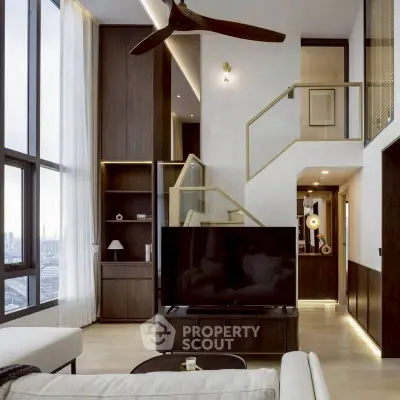 Luxurious modern living room with high ceilings and large windows offering stunning city views.