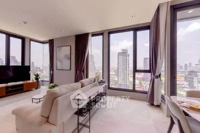 Luxurious corner unit living room with panoramic city views and elegant decor.