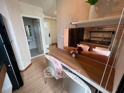Modern apartment interior with stylish kitchen and dining area, featuring sleek wooden flooring and contemporary decor.