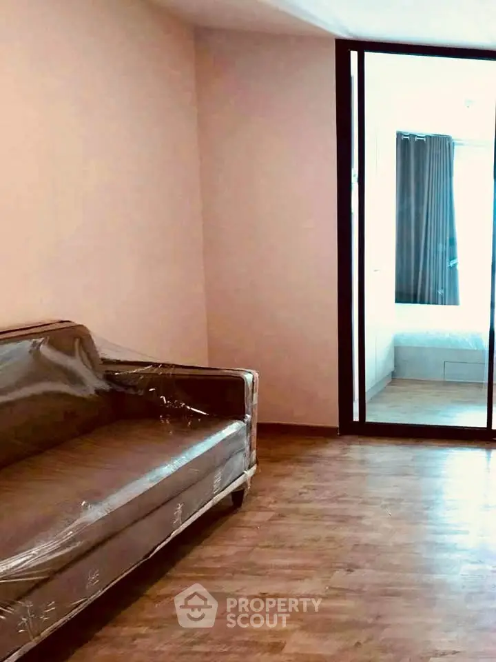 Modern apartment interior with wooden flooring and glass partition