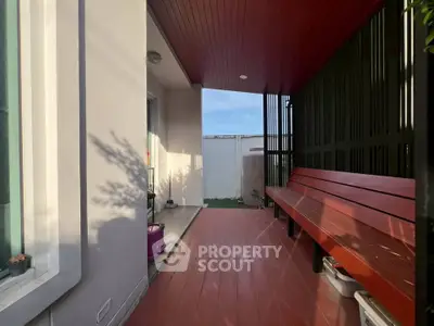 Charming outdoor balcony with wooden bench and modern design, perfect for relaxation.