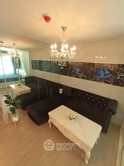Luxurious living room with elegant chandelier and plush sofa in modern apartment