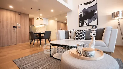 Modern living room with stylish decor and open kitchen layout in a contemporary apartment.