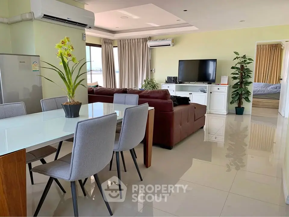 Spacious open-plan living and dining area with modern furnishings and natural light.