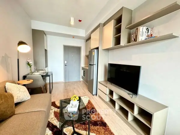 Modern living room with stylish decor and open layout, featuring a cozy sofa and sleek TV unit.