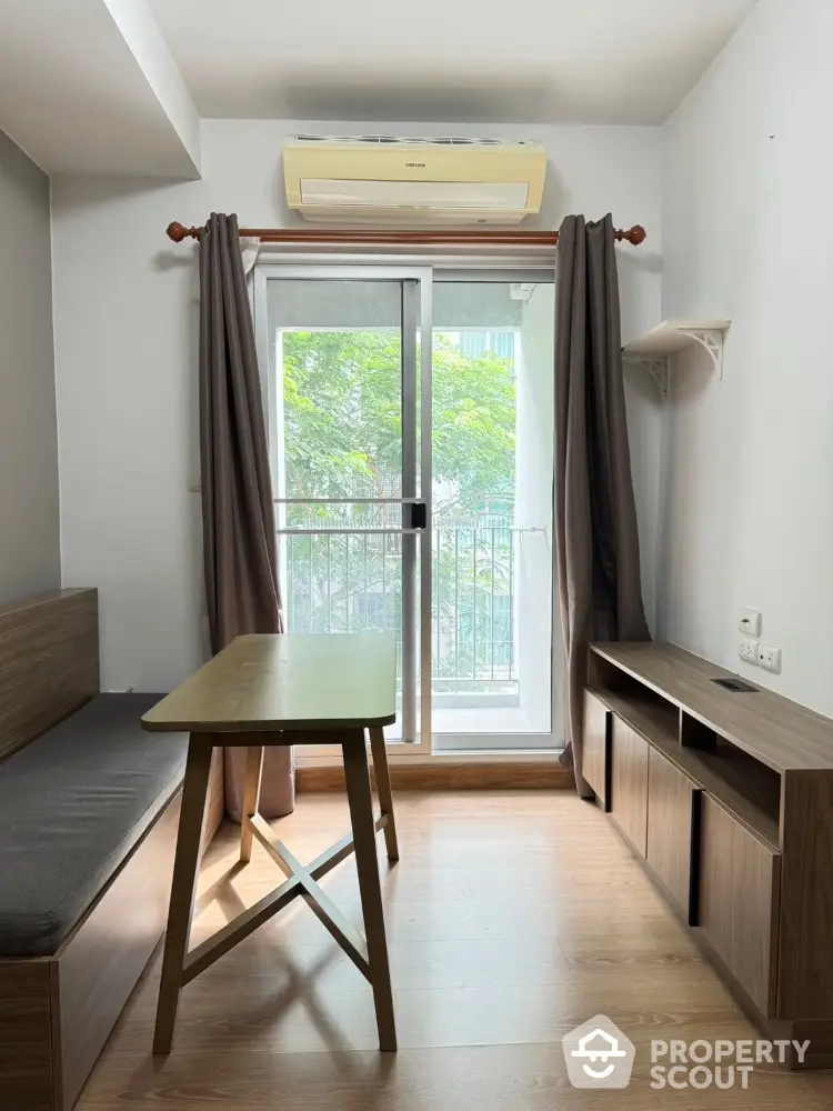 Cozy study room with wooden furniture and balcony view