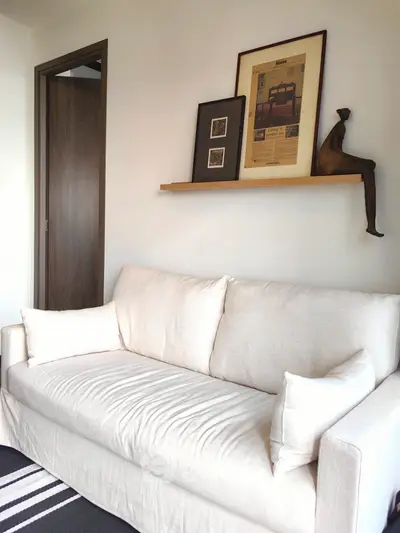 Cozy living room with elegant white sofa and artistic wall decor