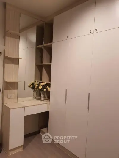 Elegant built-in wardrobe with vanity and mirror in modern bedroom