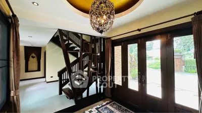 Elegant entrance with spiral staircase and chandelier in luxury home