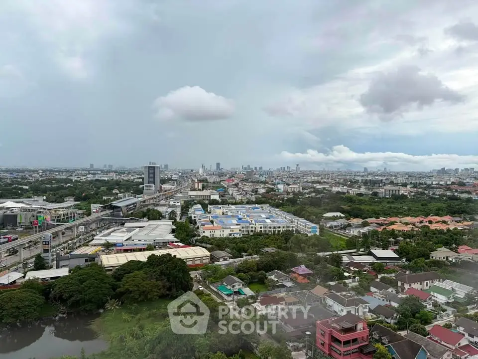 Stunning cityscape view showcasing urban skyline and residential areas under a cloudy sky.