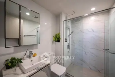 Modern bathroom with sleek design, glass shower, and elegant fixtures in a contemporary home.