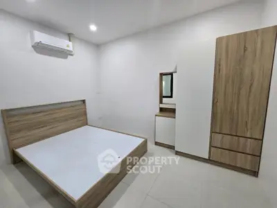 Modern minimalist bedroom with wooden furniture and air conditioning